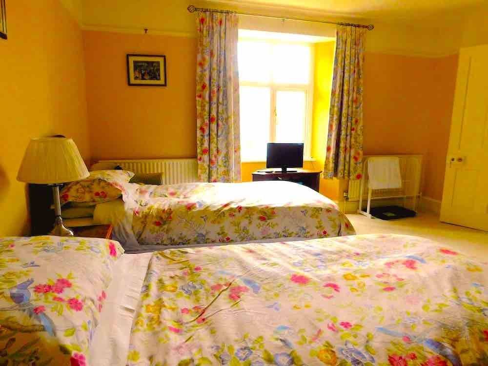 Twin bedroom at hall farm house with £70/per night price label